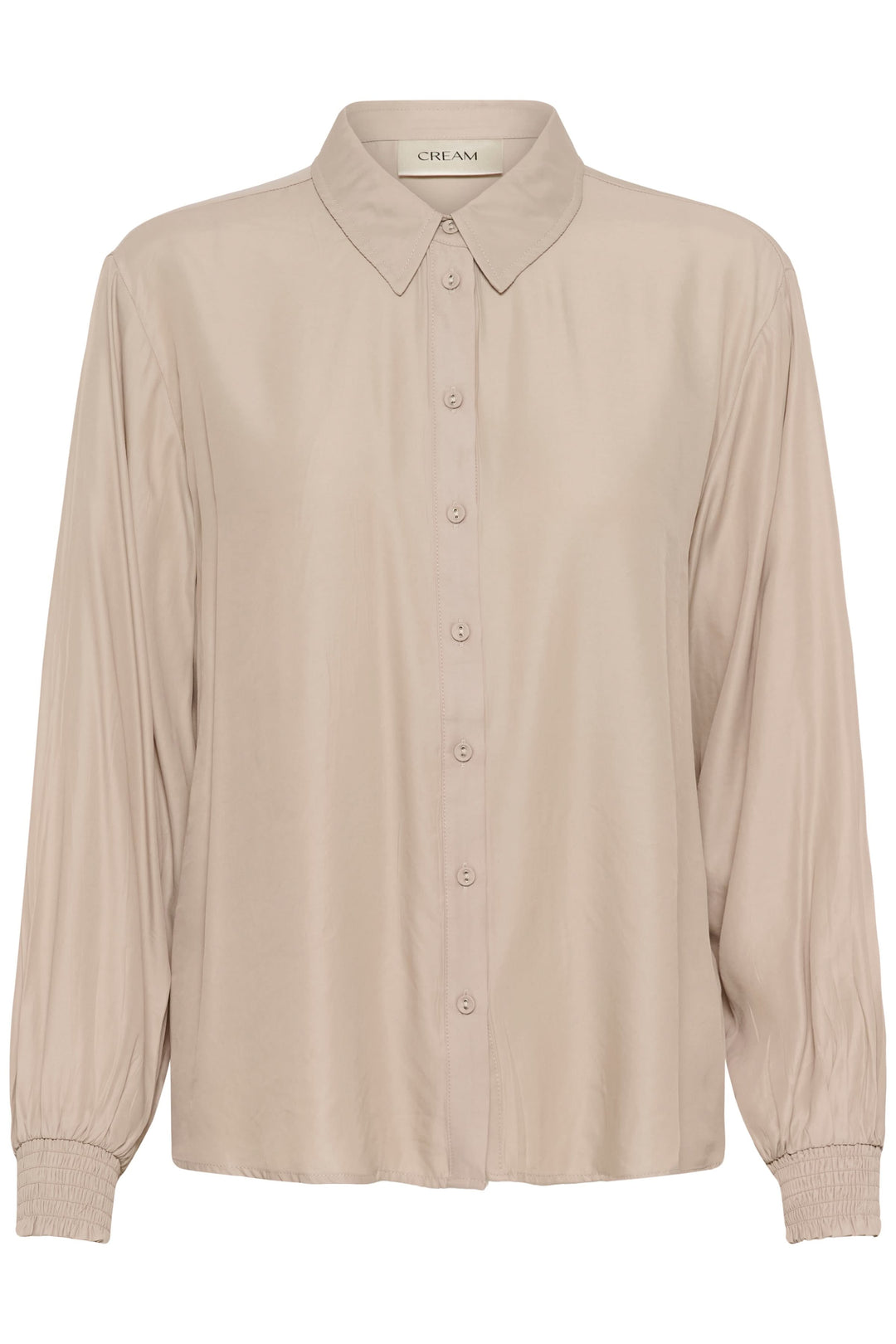 Blouse Nola fluide à poignets smockés, élégante blouse pour tenues de travail ou week-end, couleur neutre avec boutonnière classique.