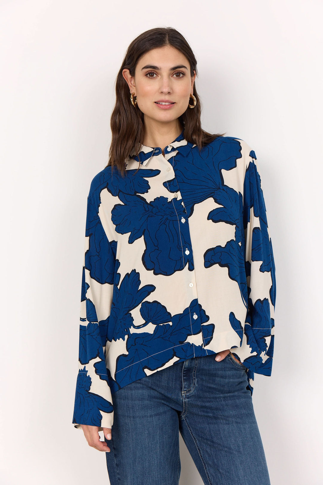 Chemise oversize à imprimé floral bleu et crème, coupe fluide et décontractée, portée avec un jean.