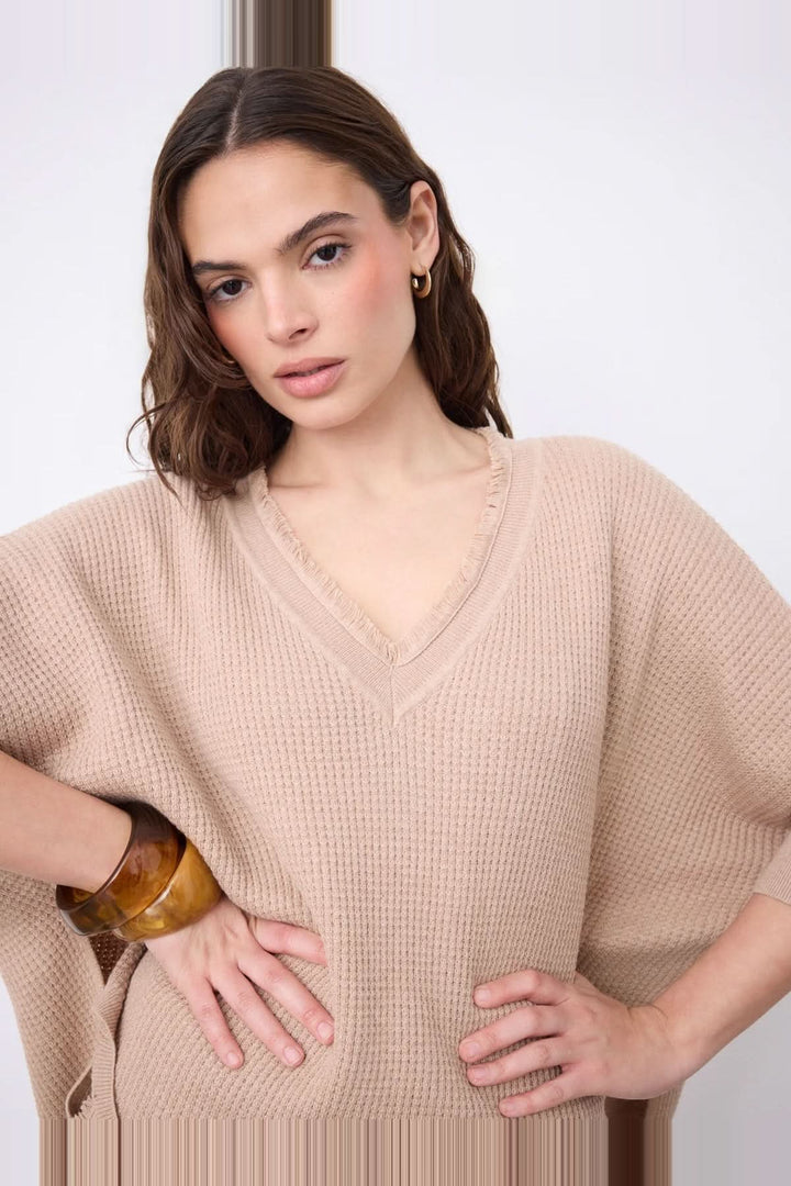 V-neck poncho sweater with three-quarter sleeves