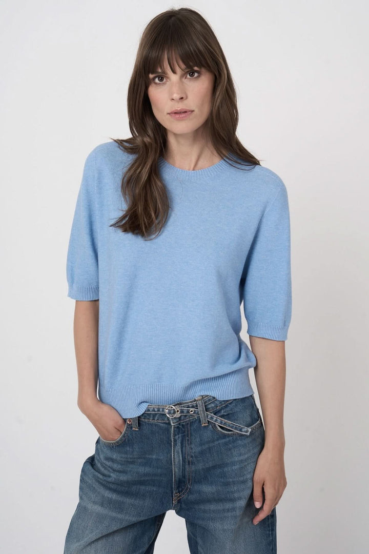 Tricot à manches courtes bleu pour un style élégant et minimaliste.