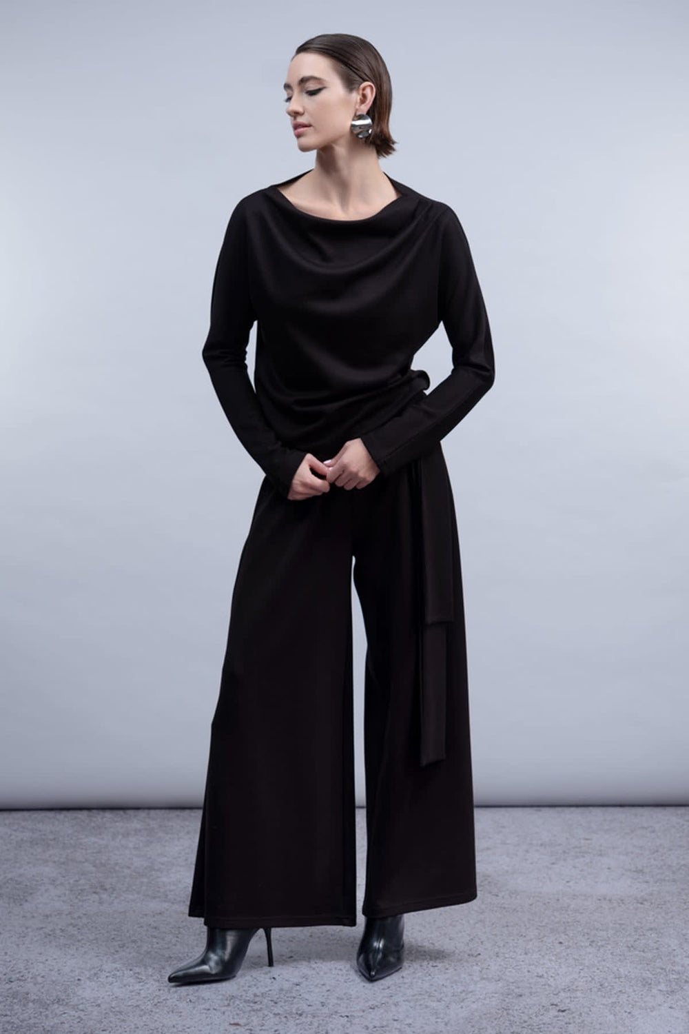 Front view of the Haako women's red draped-collar sweater with a cable-knit pattern - Valérie Simon