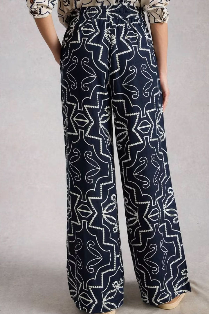 Pantalon fluide imprimé à jambe large avec motif graphique, taille élastique, coupe ample pour un confort élégant au quotidien.