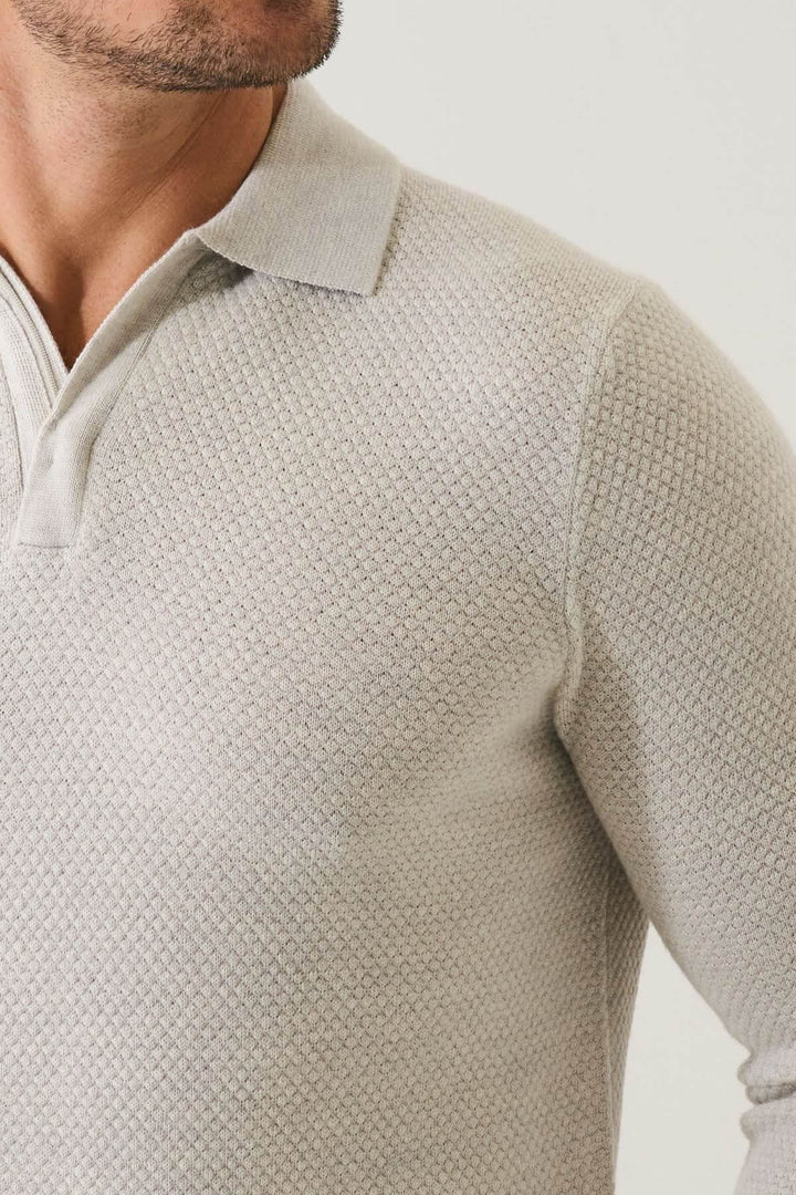 Polo zippé texturé en laine mérinos extra-fine