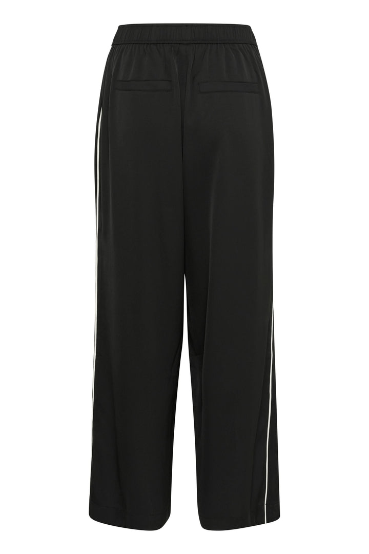 Pantalon Tessa en noir, fluide avec taille élastique et poches, jambe large et élégante.