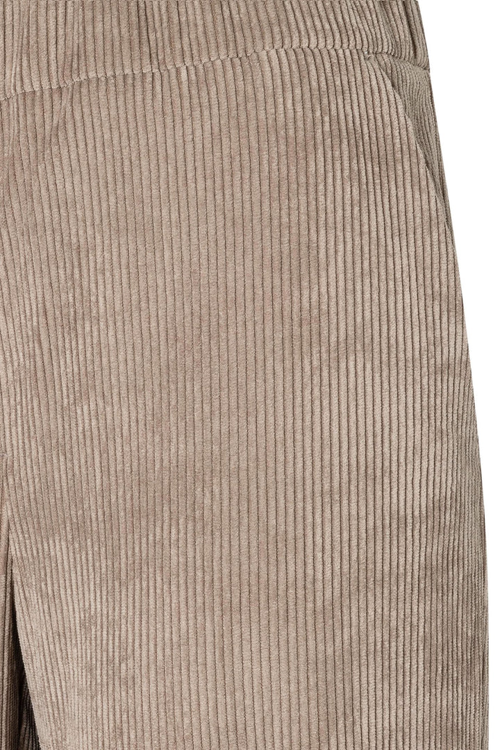 Pantalon en velours côtelé avec taille élastique et poches latérales, style rétro et sophistiqué.