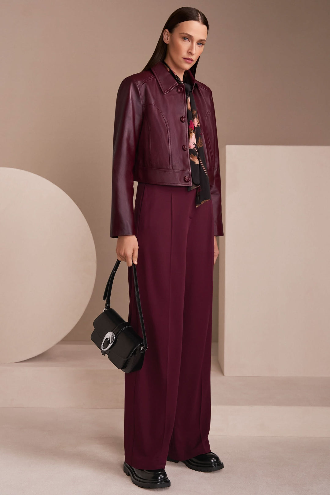 Veste en cuir bordeaux avec pantalon large, look moderne et élégant, idéal pour un style chic et contemporain.