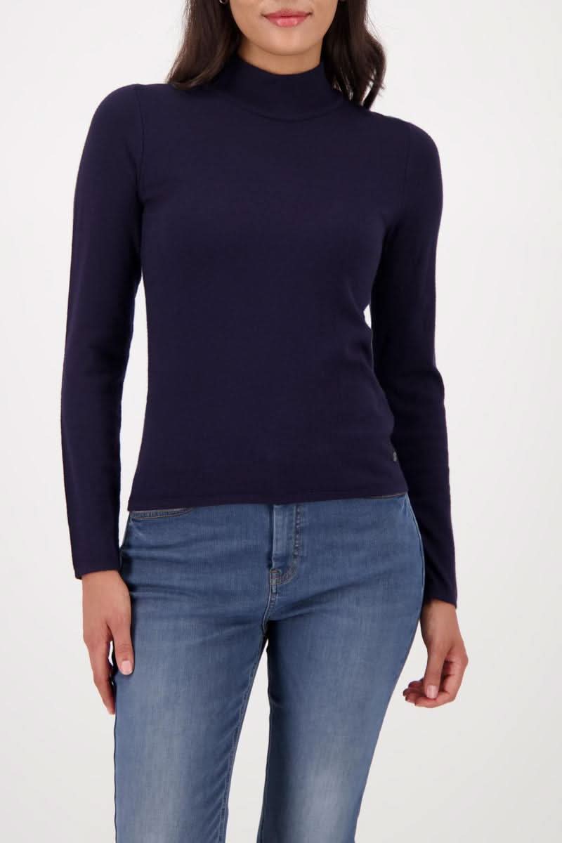 Chandail à col montant ajusté en tricot doux porté par un mannequin, idéal pour un look professionnel ou décontracté.