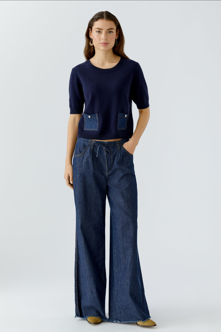 Femme portant un jean ultra léger à coupe large et un haut cintré avec poches avant.