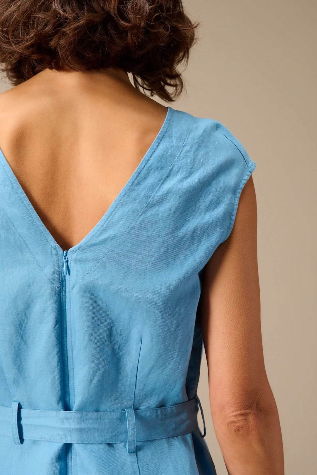 Sleeveless jumpsuit with a tie-waist belt