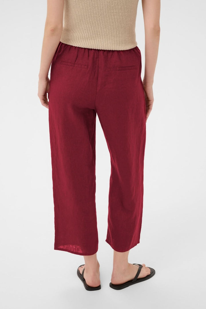 Pantalon de lin Berita en tissu léger rouge avec taille élastique et cordon, coupe droite fluide, idéal pour style décontracté.