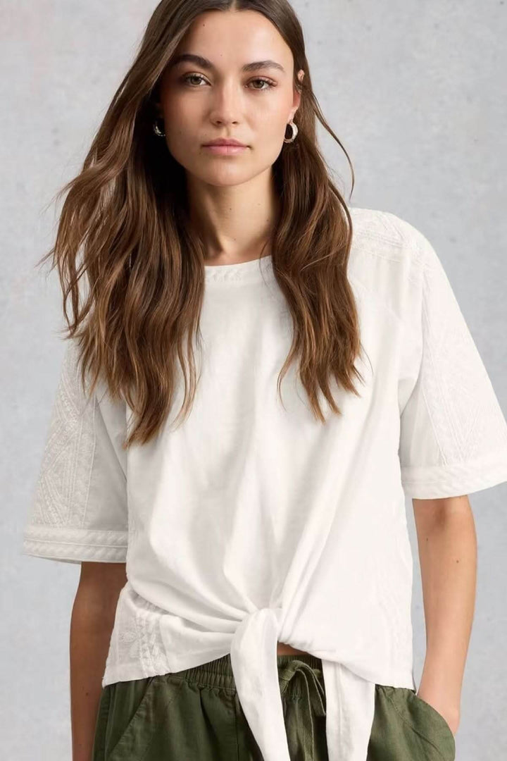 Embroidered crew-neck top with a bow hem