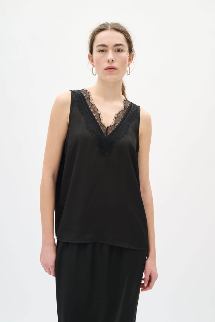 Camisole Danica en satin à encolure dentelle, femme portant haut noir en satin avec dentelle, look chic et intemporel
