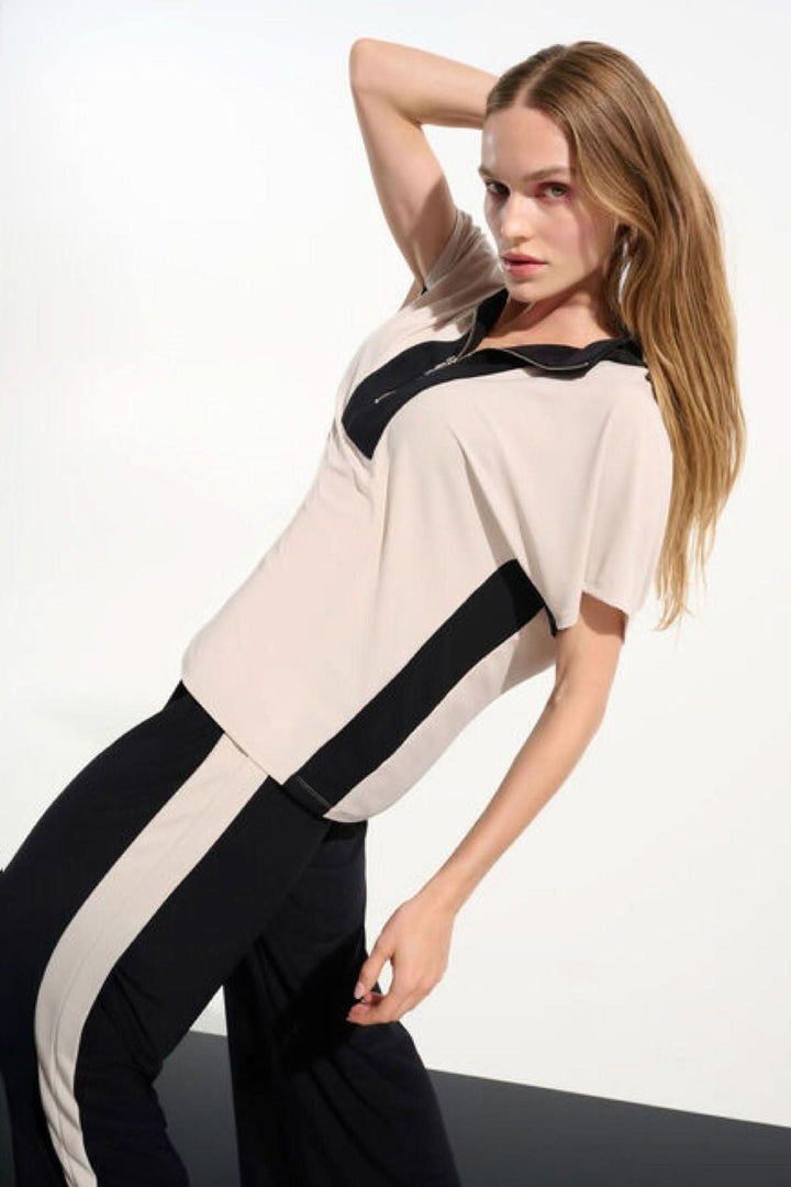 Haut à col zippé structuré, moderne et épuré, avec col montant et fermeture à glissière, pour une garde-robe polyvalente.