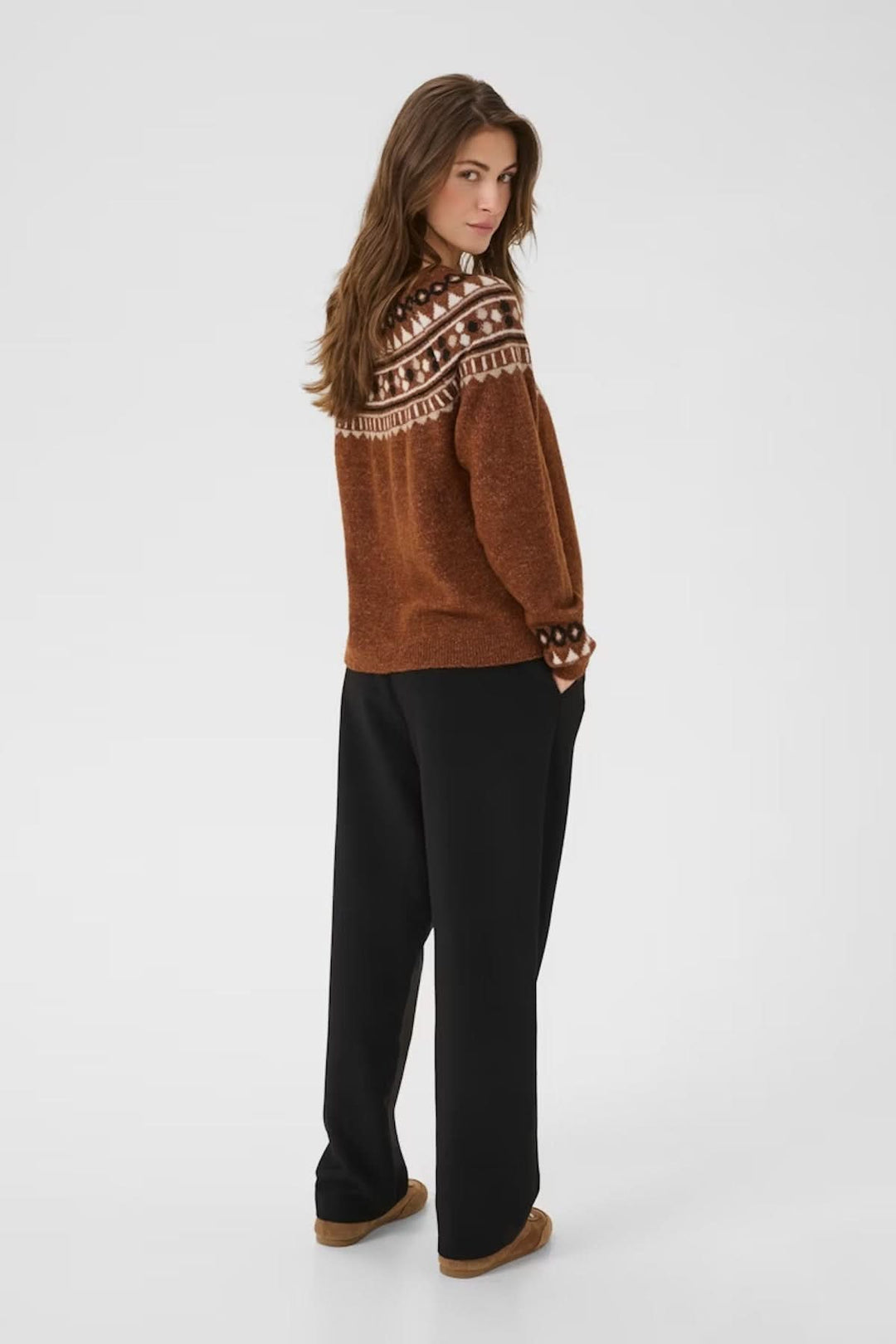 Chandail à motif jacquard nordique, coupe confortable, caramel, porté avec pantalon noir, look hivernal douillet.