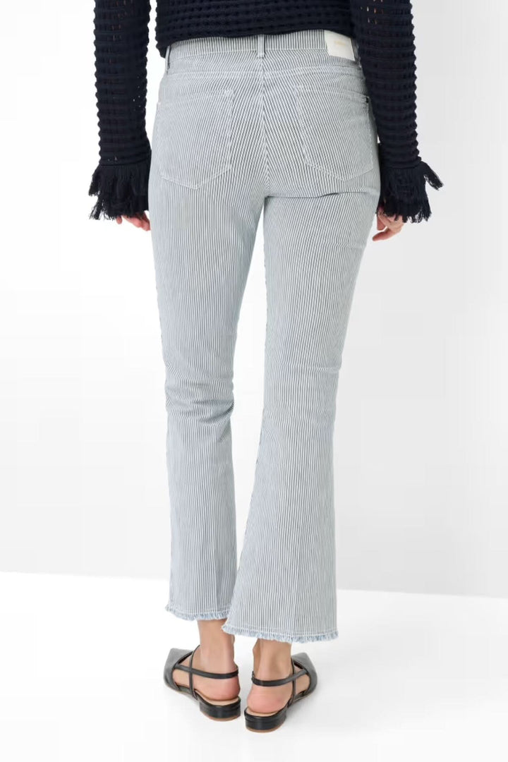 Vue arrière du Jeans SHAKIRA avec coupe ajustée et bas évasé, motif à fines rayures, porté avec un pull noir et sandales.