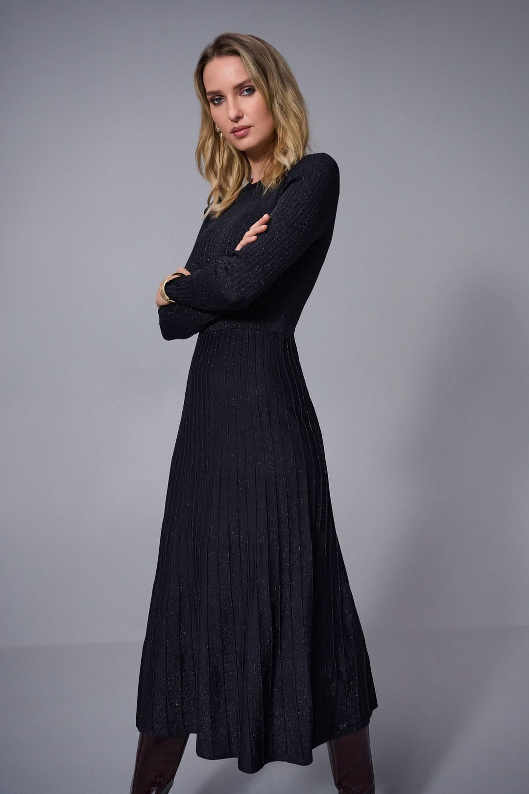 Robe élégante en tricot noir à manches longues, avec une jupe fluide et une encolure ronde, parfaite pour l'automne/hiver.