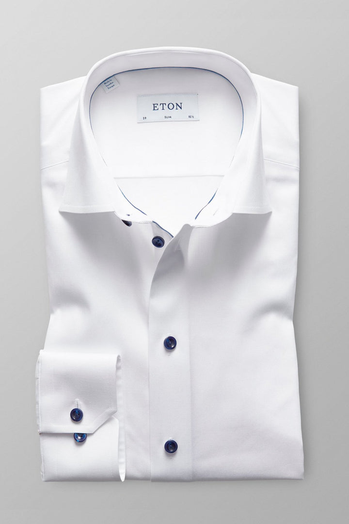 White shirt with navy buttons