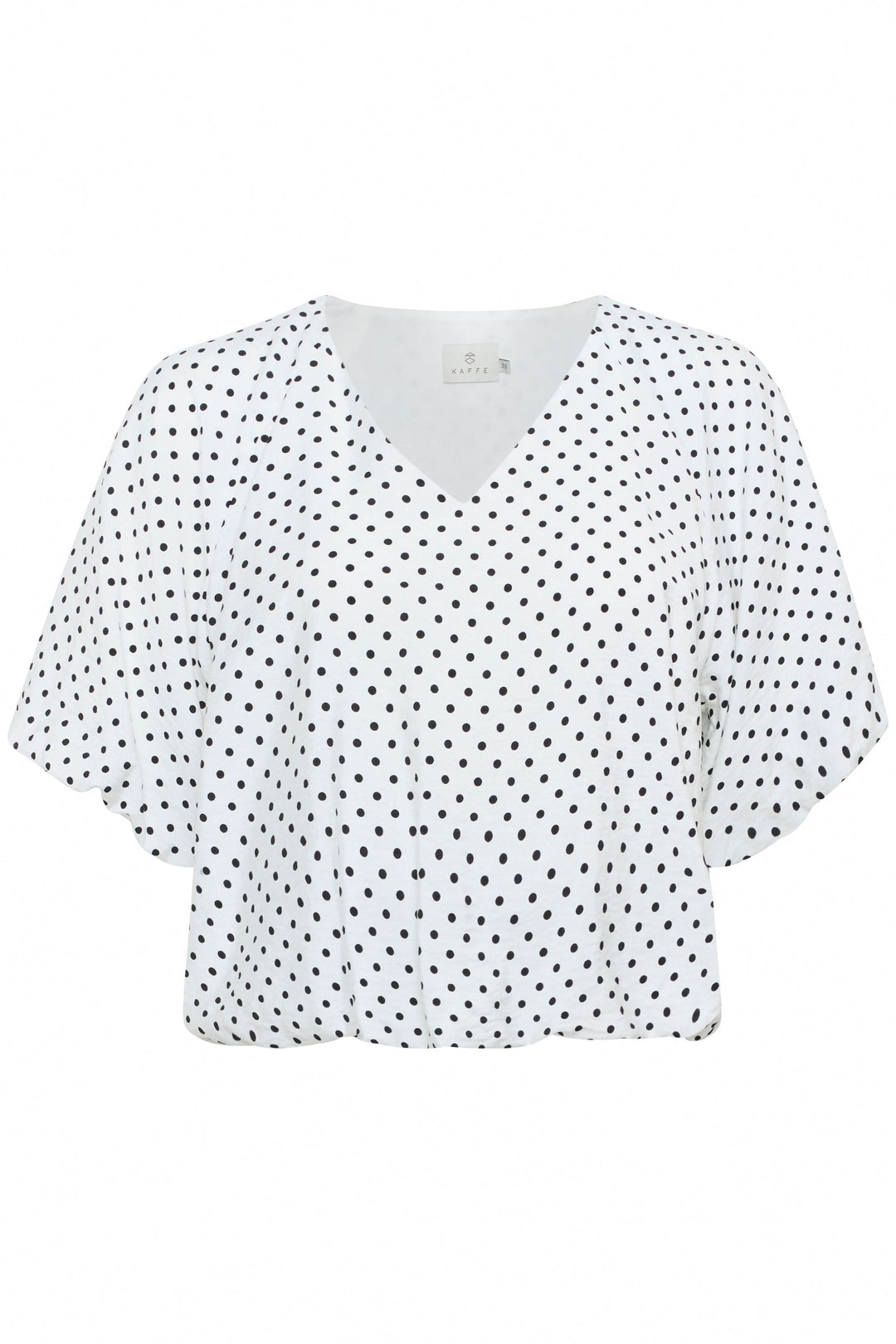 Blouse Gwen à pois avec encolure en V et manches amples, idéale pour une silhouette moderne et confortable.