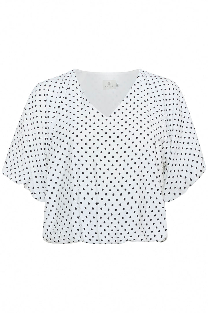 Blouse Gwen à pois avec encolure en V et manches amples, idéale pour une silhouette moderne et confortable.