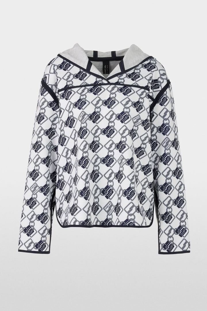 Chandail à capuche réversible avec motif géométrique moderne et coupe ample, côté imprimé.
