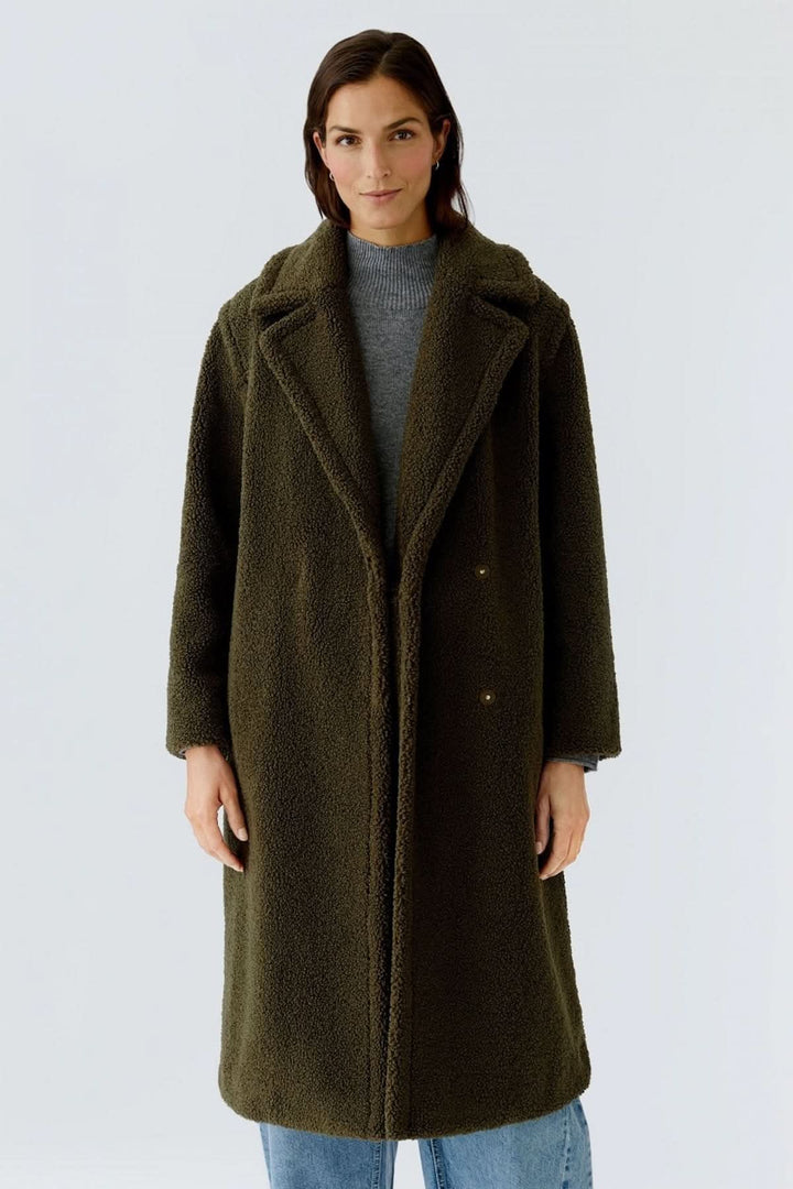 Alt Tag: Manteau long en tissu bouclette, élégant et confortable, porté sur un jean. Parfait pour les journées froides, coupe droite douillette.
