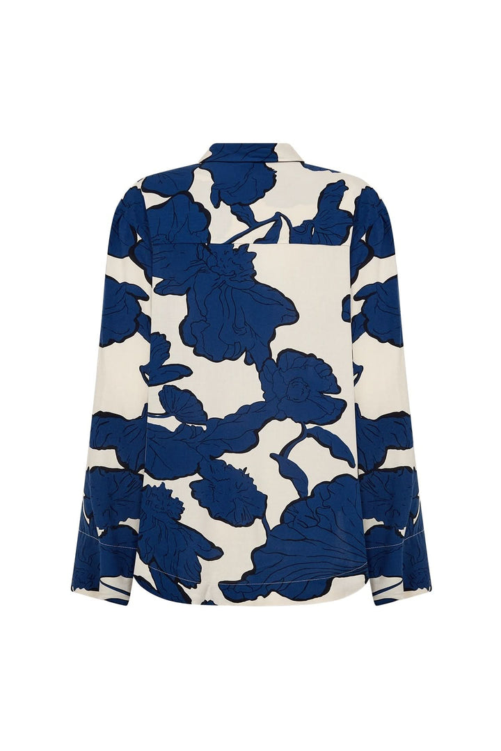 Dos d'une chemise à imprimé floral bleu sur fond crème, style oversize et coupe fluide.