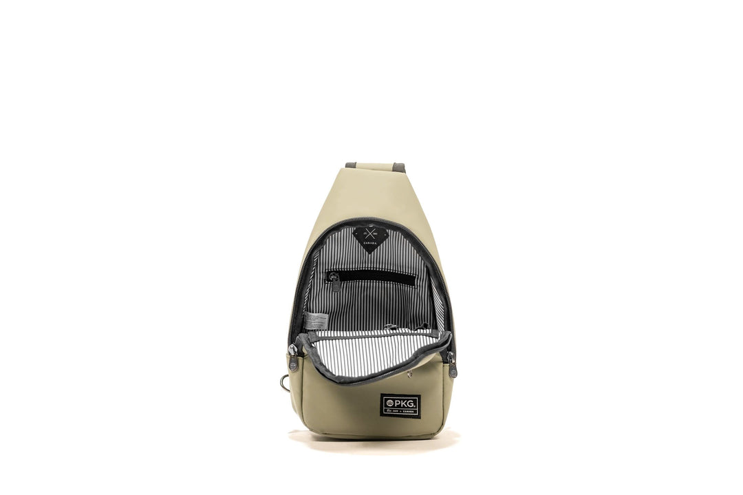 Open view of the PKG Elora Recycled Cross Body, featuring waterproof material and striped interior pockets.