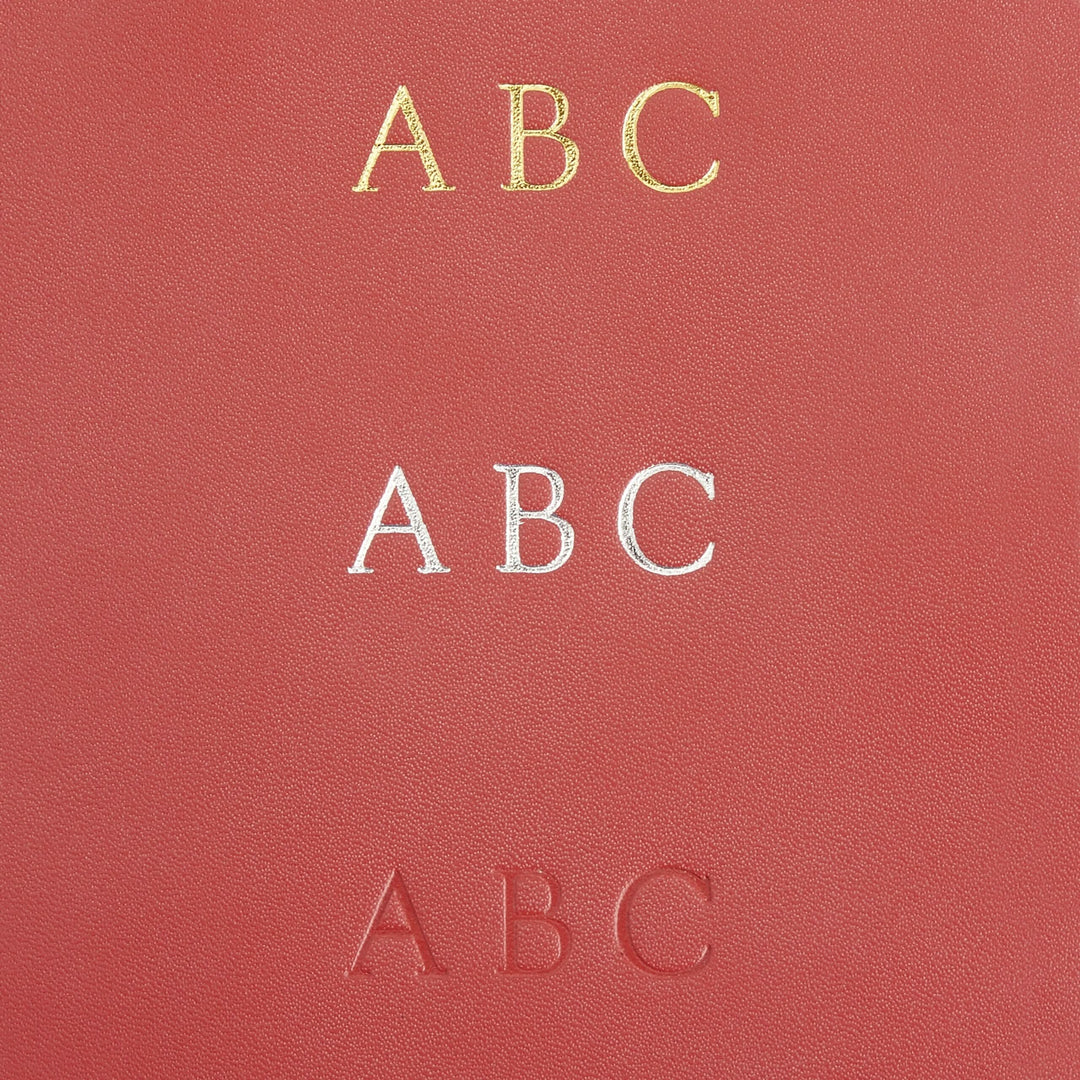 Elegant red wallet featuring embossed and foil stamped 'ABC' designs for stylish identification storage.