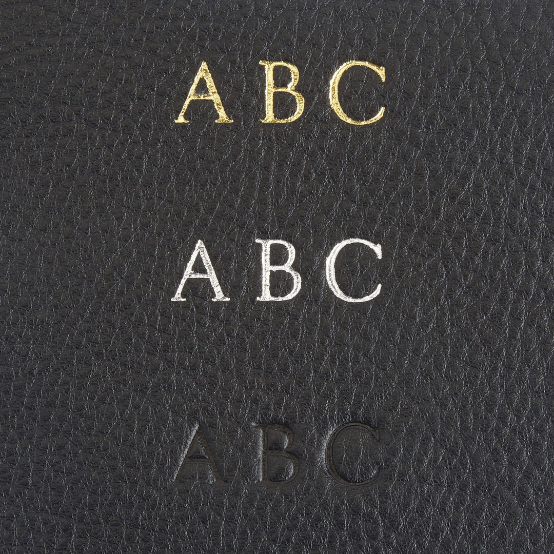 Monogram personalization options on black leather featuring gold, silver, and debossed initials.