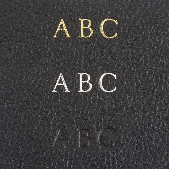 Monogram personalization options on black leather featuring gold, silver, and debossed initials.